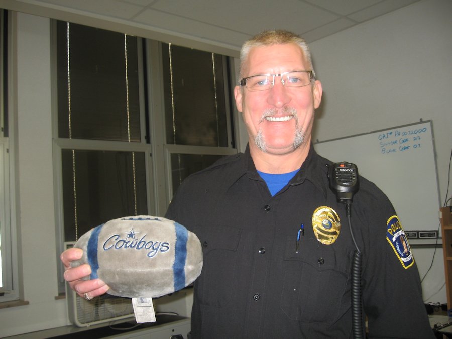 Officer Bub shows off a football with his beloved Dallas Cowboys logo.