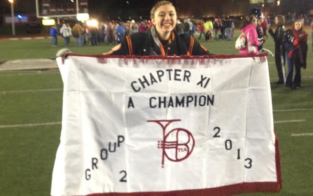 Junior Samantha Aungst holds the championship banner after winning 1st place.