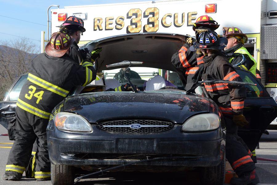 Tyrone firefighters removing the roof from the car to safely extract the victims.