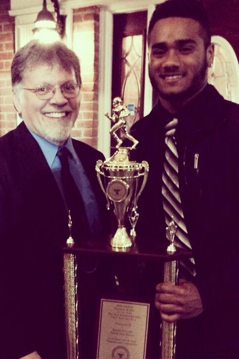 Mr McNitt and James Oliver pose with the Blair County NAACP Football Player of the Year Award.