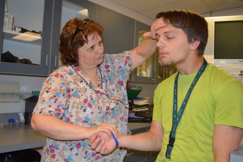 School nurse Julie Patton checks senior Johnny Paine for symptoms of the Senioritis virus.