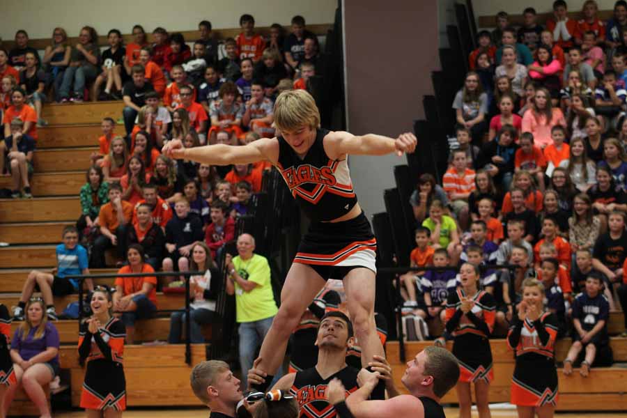 Ty Snyder, Garrett Hunter, Silas Crawford, and Mark Lewis performing their cheerleading routine 