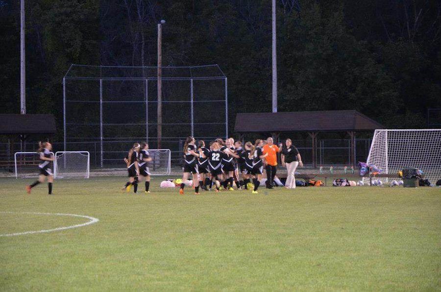 The Lady Eagles celebrating after a win against the Lady Bearcats