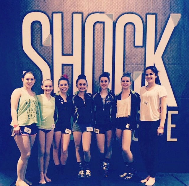 Dancers posed in front of convention sign (from left to right): Gabby Whetstine, Natalie Berrena Barr, Mary Beth Raabe, Faythe Lewis, Haley Wagner, Justice Myers, and Davina Lee