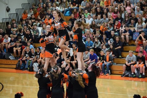 The Varsity cheerleading squad doing their stunts.
