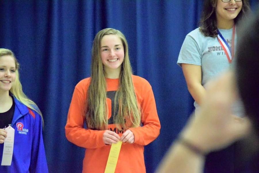 Emily on the podium for the 100 fly