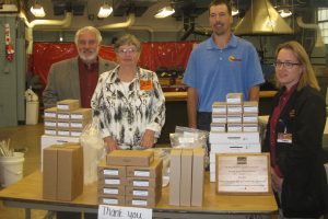 Bill and Deb Hoover, Clint Black and Tiffany Hoy are pictured with the wooden plaque and some of the Vernier equipment purchased with the grant.