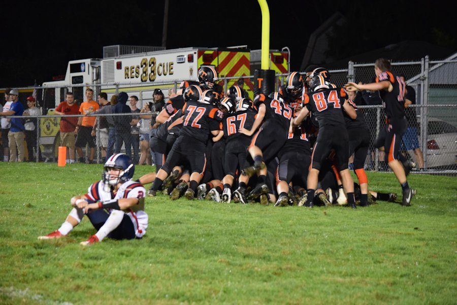 Tyrone players pile on Brandon Loose following his game winning overtime touchdown against Huntingdon.