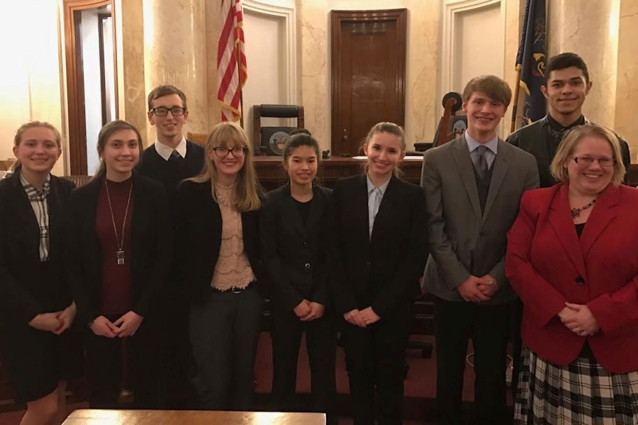 Megan Dale, Alicia Endress, Jonathan Clifton, Sarah Meyer, Ebonee Rice, Morgan Bridges, Brent McNeel, and Brandon Escala pictured with the judge of the trial.
