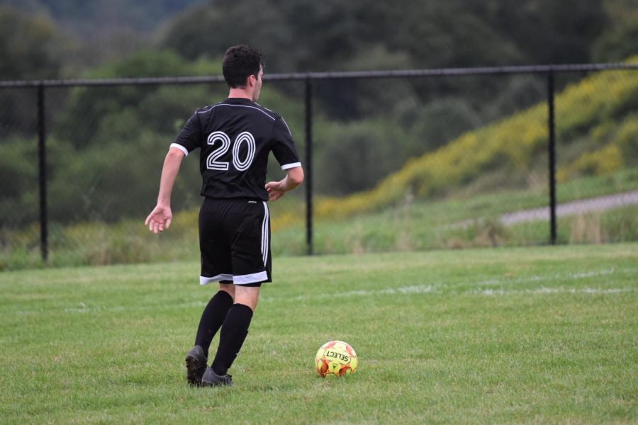 Junior Nick Vasbinder carries the ball up field and looks for an open lane.