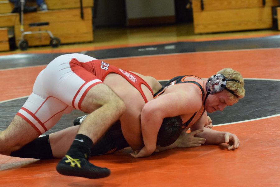 Braeden Ray moves into a head lock on his opponent.