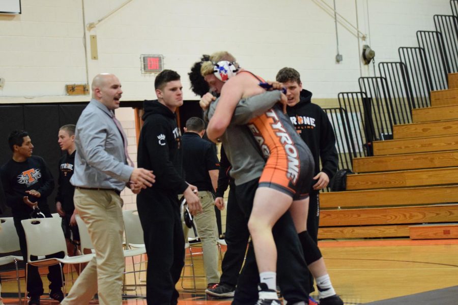 Coach Tate, Jack Lewis and Tommy Hicks congratulate Braeden Nevling-Ray for his win.