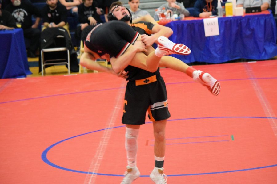 Sophomore Hunter Walk picks up his opponent to bag his body.