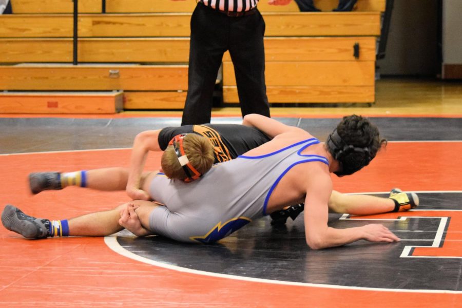 Junior Mason Walls wrapping his opponent legs.