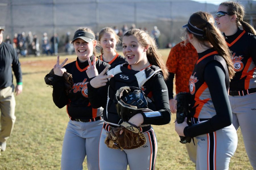 Juniors, Ally Jones and Callie Maceno throwing up peace signs in between innings.