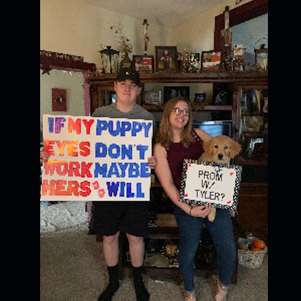 Anna Beck and Tyler Gunsallus with their promposal and their puppy.