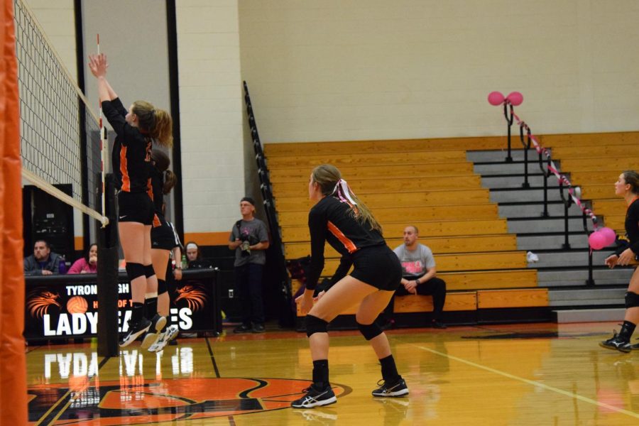 Makenna Bauer sets up defense behind Courtney Williams' and Miranda Goodman's block during last year's DIG PINK game.