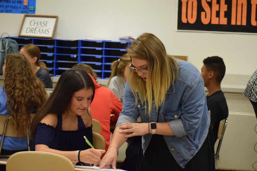 Miss Rayne Young is the math Americorps teacher  for the 2019-2020 school year.  Here she helps junior Mattie Cherry.