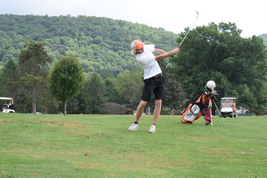 Jake Taylor hitting an iron on the fairway.