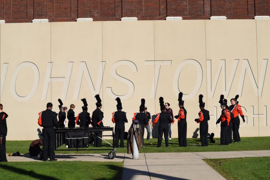 Tyrone band performing in front of the Johnstown High School sign.