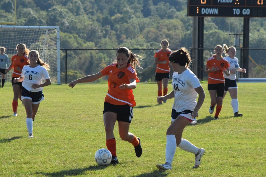 Freshman Chloe LaRosa dribbles the ball away from a Penns Valley defender.