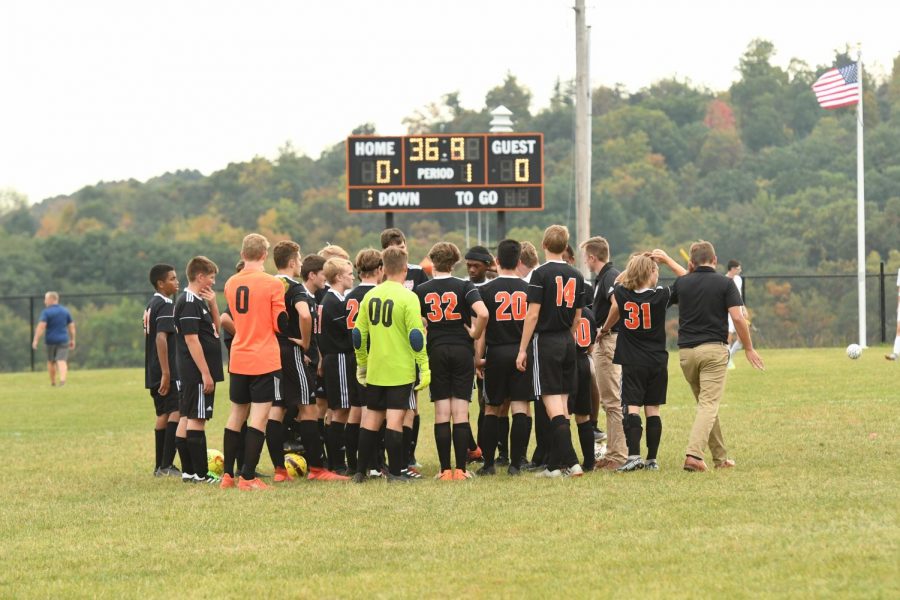 Tyrone players and coaches huddling before the game.