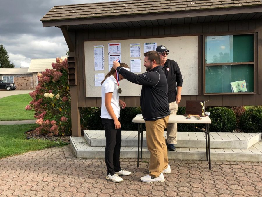 Coach Funicelli presenting Cassidys medal. 