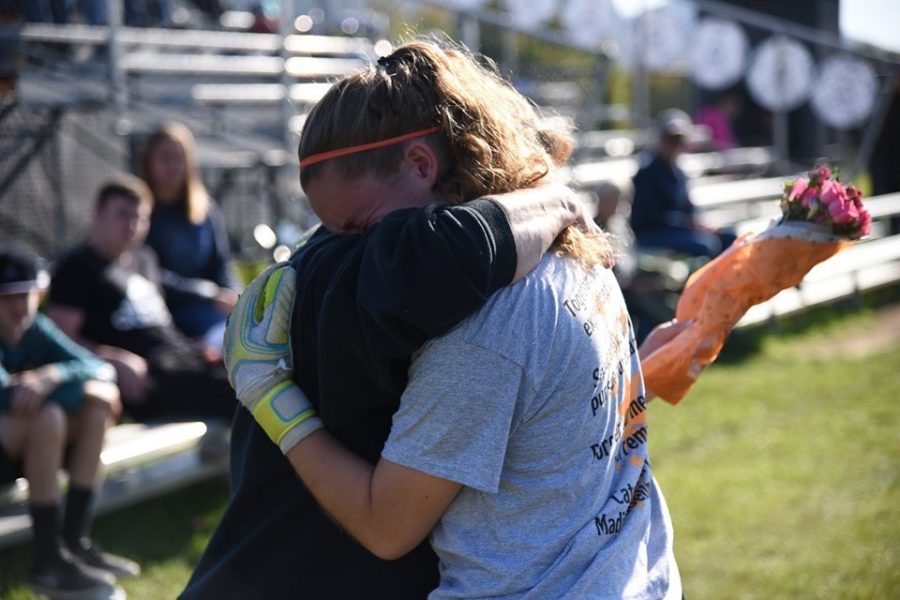 Rayann Walls hugging her mom,with tears in her eyes, after giving her flowers