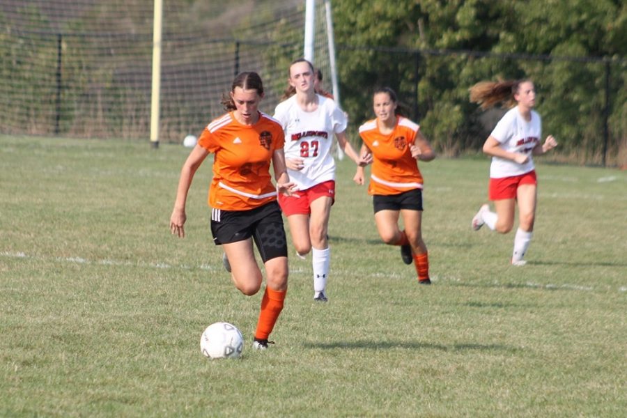 Freshman, Avalyn Moore dribbling the ball down the field, towards the goal.