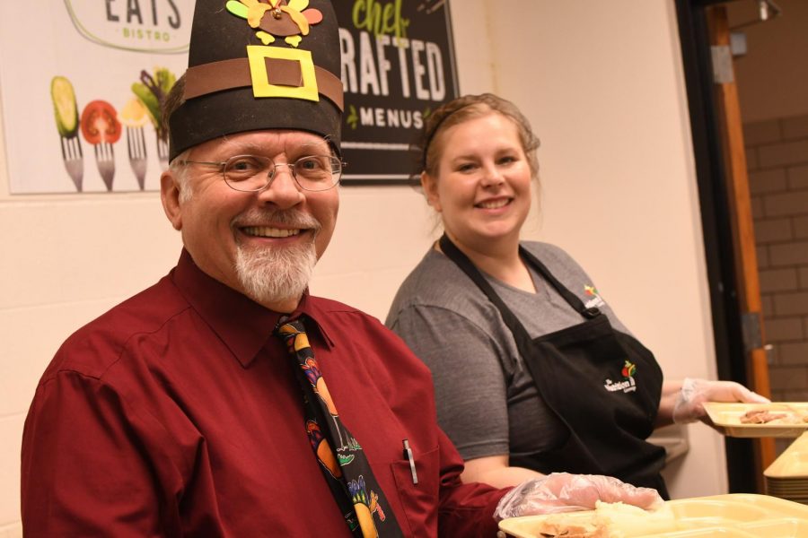 Social studies teacher Cummins McNitt and Food Service Director Amanda Grove serving the good stuff at the annual Thanksgiving dinner at the TAHS cafeteria during last years TAHS Thanksgiving lunch in 2019.