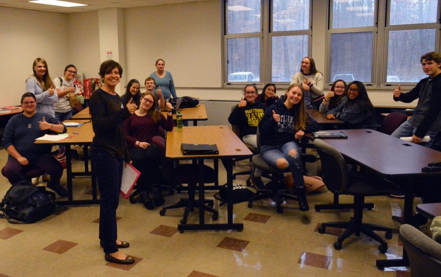 Mrs. Leah Deskevich (standing, front) returns to TAHS to help lead the Speech Team, along with her Co-Adviser Gabby McLarren (far back center).