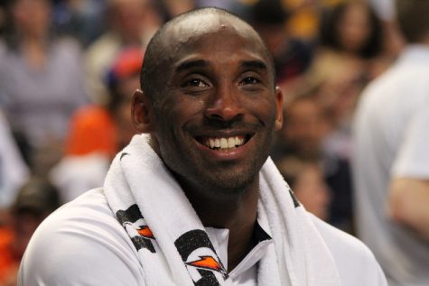 Kobe Bryant smiling on the bench