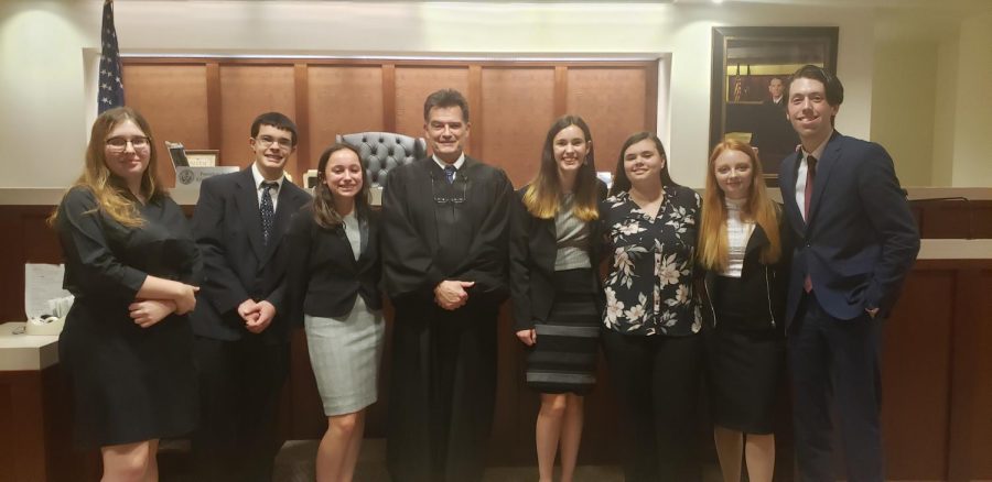 The Mock Trial B Team gets a photo with the judge after their trial.