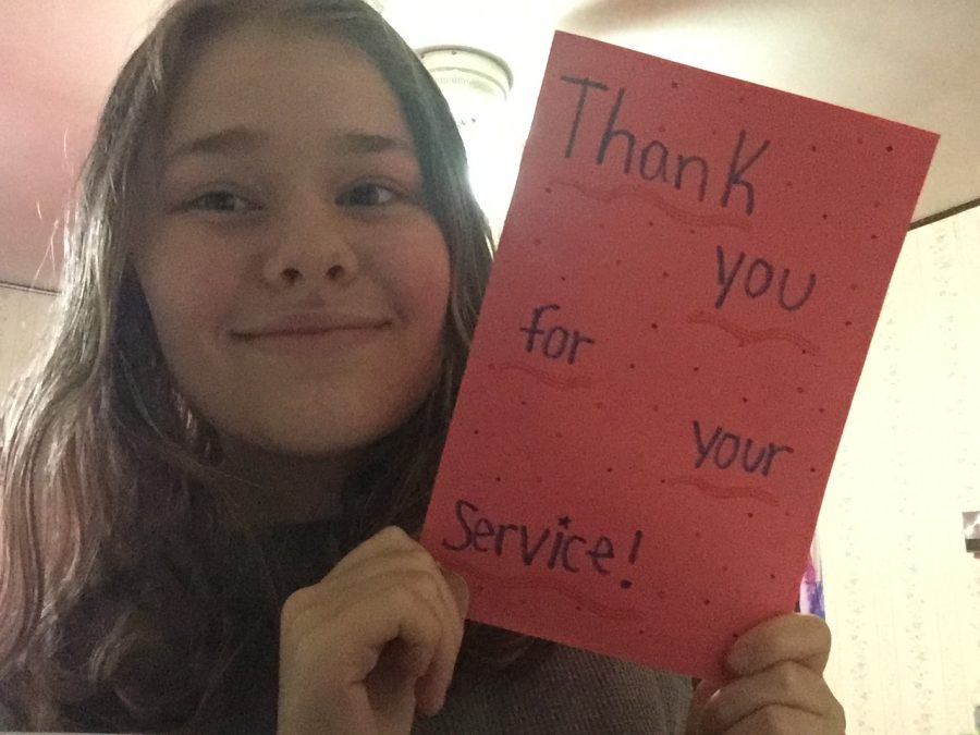 TAHS student Sarah Christofer with one of the handmade cards for veterans that will be sent to the VA Hospital in Altoona.