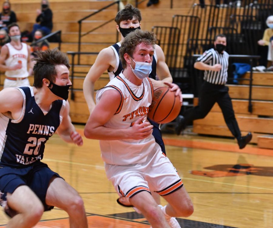 A masked Cortlynd Rhodes drives to the basket against Penns Valley earlier this season.  Tyrone boys have played some games with masks, and others without masks this season.