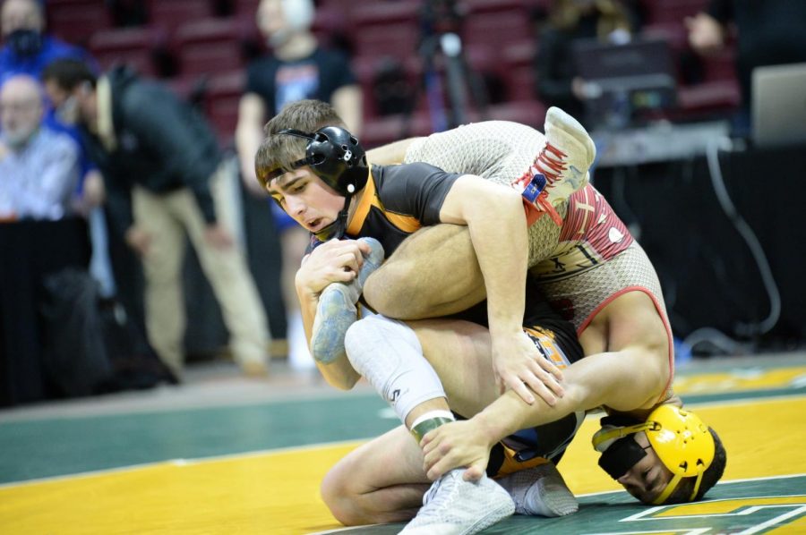 Tyrones Hunter Walk battles Bishop McCorts Mason Gibson at the Regional Tournament in Altoona.