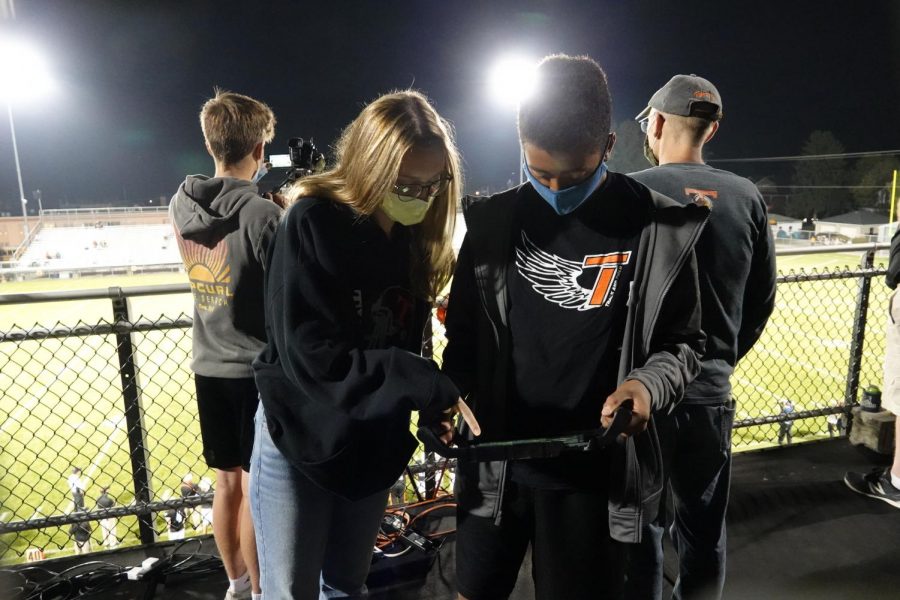 Eagle Eye News students Avalynn Moore and Brayden Daniels control the live stream via an iPad controller.