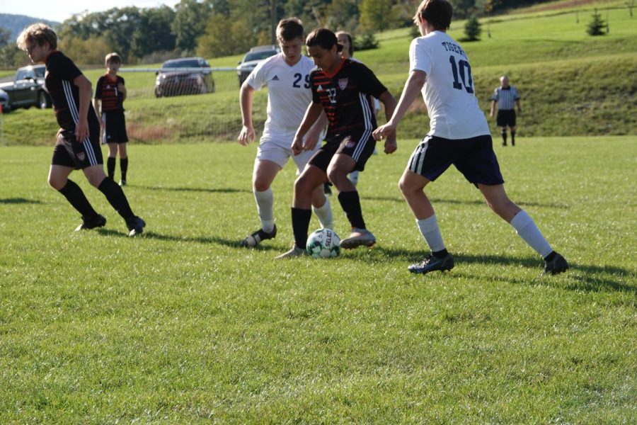 Sophomore Rocky Romani dribbling the ball through defenders
