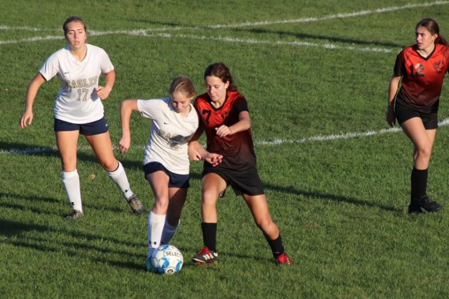 Freshman Rylie Andrews defending the ball from an opposing player.