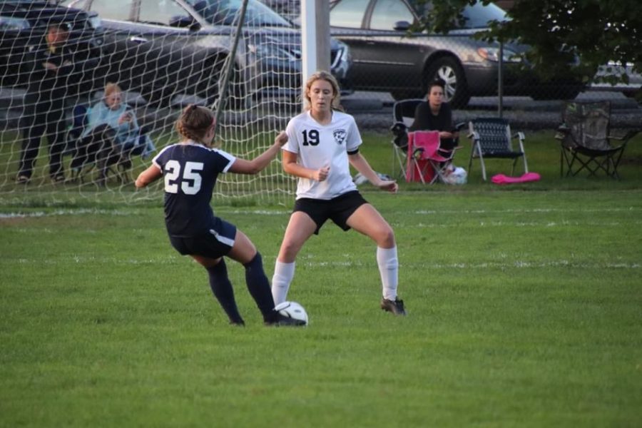Senior Natalie Saltsgiver getting ready to defend the goal from a potential shot.