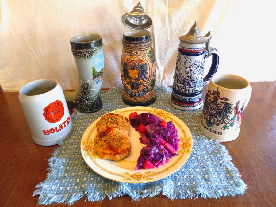A plate of schnitzel and red cabbage backdropped by an adornment of german mugs.