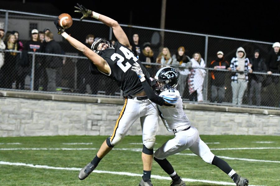 Ross Gampe catching a ball in the end zone over a defender