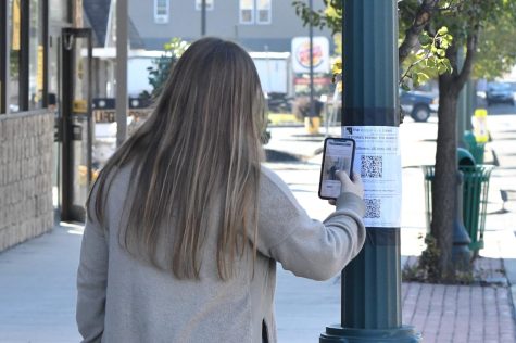 student pointing phone toward QR code