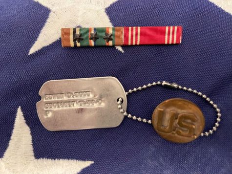 dog tags and military medals on a flag