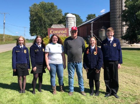 Four of the seven Tyrone Area FFA officers took a photo with Sam and Elizabeth Conrad who generously donated money towards the chapter.