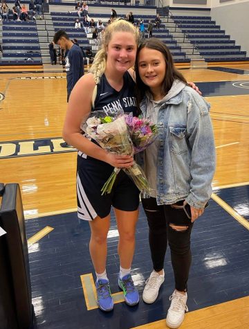 Cannistraci and Christine posing together with flowers