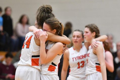 Seniors Jaida Parker. and Stephanie Ramsey console each other after the final buzzer with fwllow seniors Emma Getz and Marissa Lewis in the background.