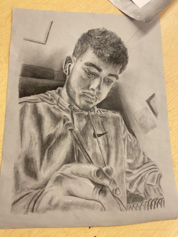 penicil portrait drawing of a male student working on his artwork 