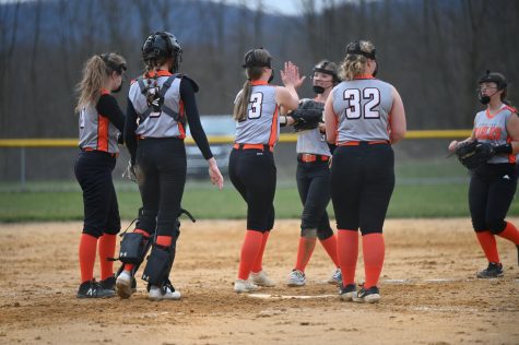 The Lady Eagles celebrate an out in the fourth inning. 