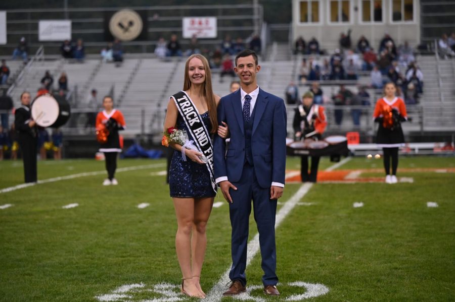 Reagan Irons representing track and field and escorted by Evan Boone.